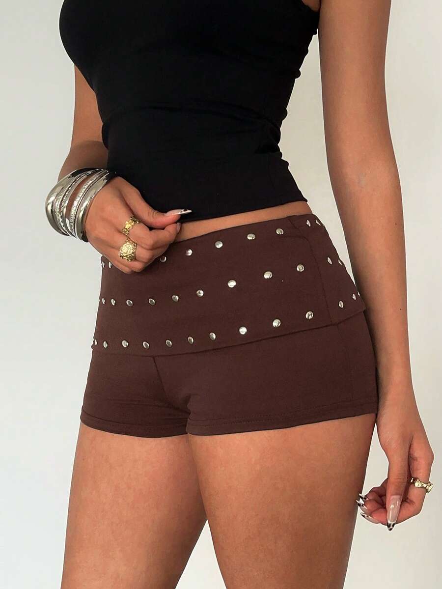 Women's studded PU ultra low waist mini shorts with zipper fly closure, skinny fit, mini length, and plain unlined design.