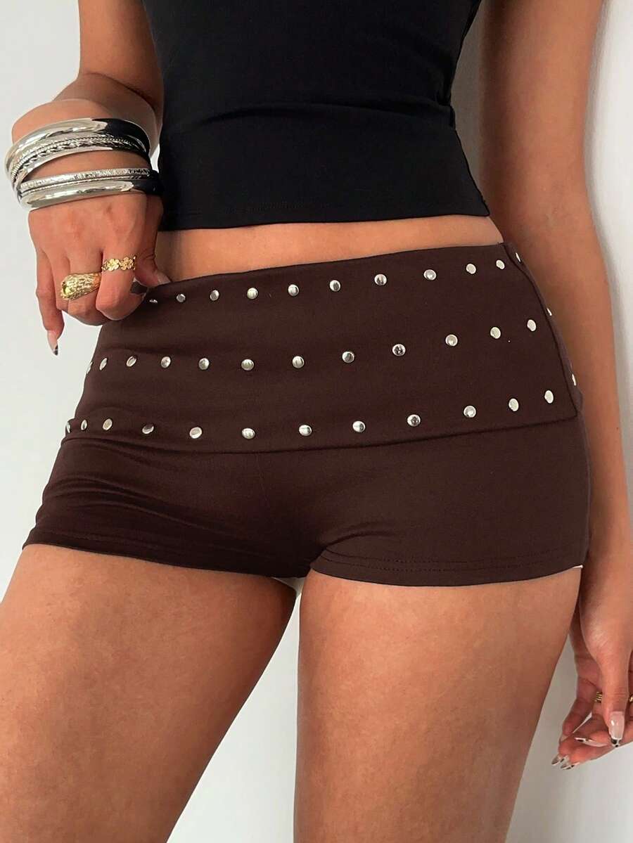 Women's studded PU ultra low waist mini shorts with zipper fly closure, skinny fit, mini length, and plain unlined design.