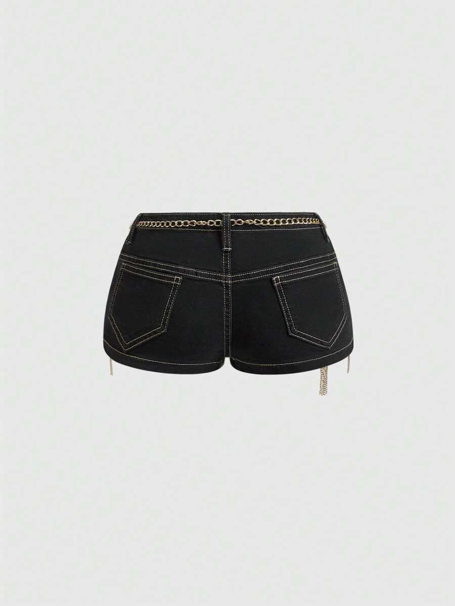 Ultra low-rise stretch denim mini shorts featuring a metal chain with cross pendant and rhinestone detailing.