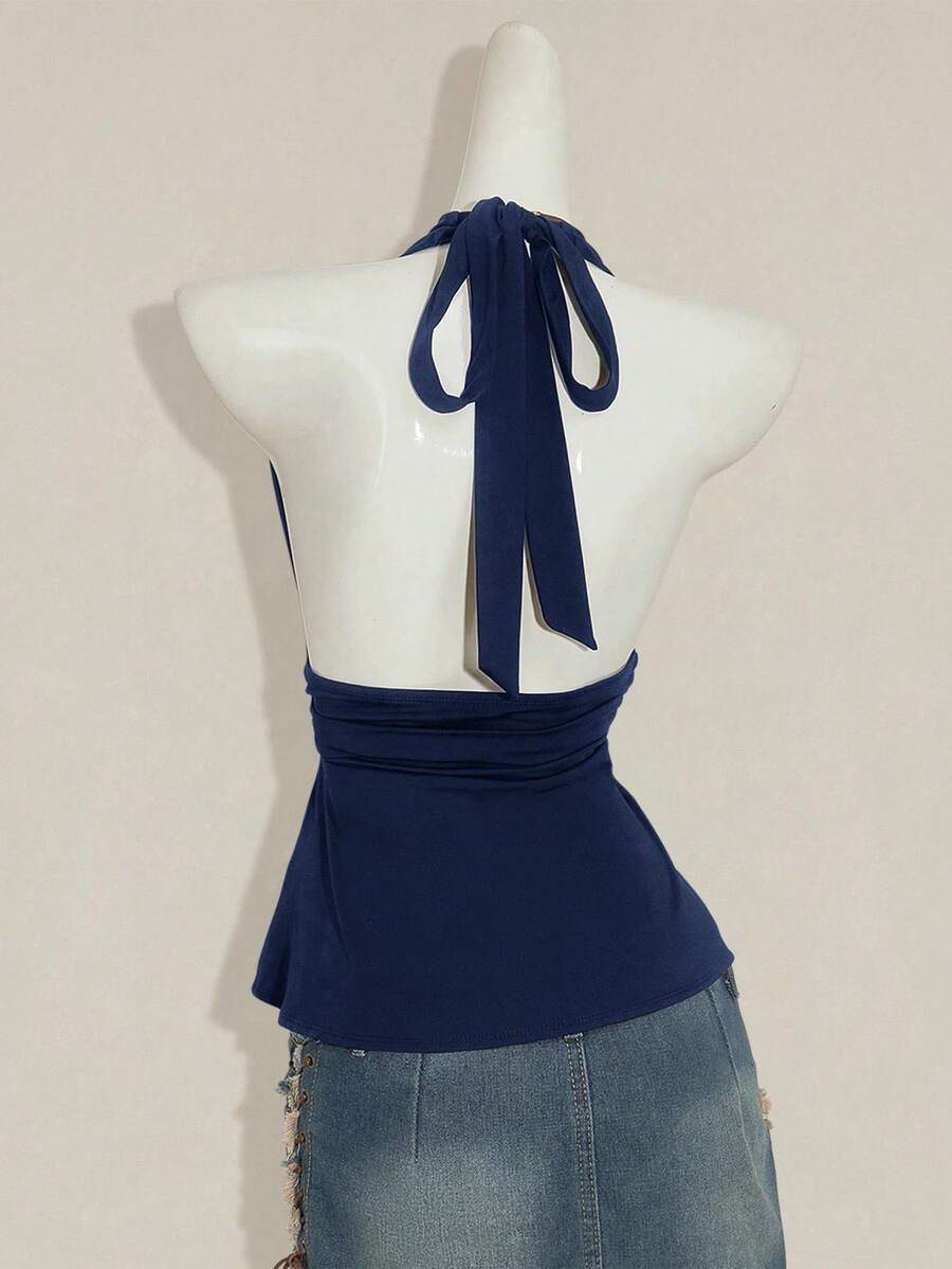 Women's backless halter babydoll tank top featuring a square neckline, slim fit silhouette, and a flared ruffle hem.