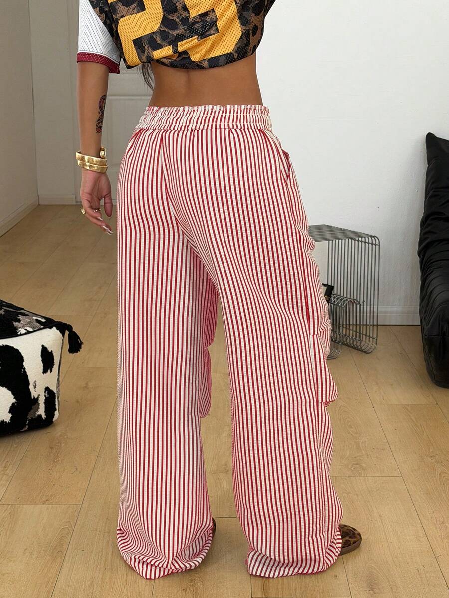 Women's black and white striped wide leg pants featuring an elastic drawstring waistband, side pockets, and a loose straight leg fit.