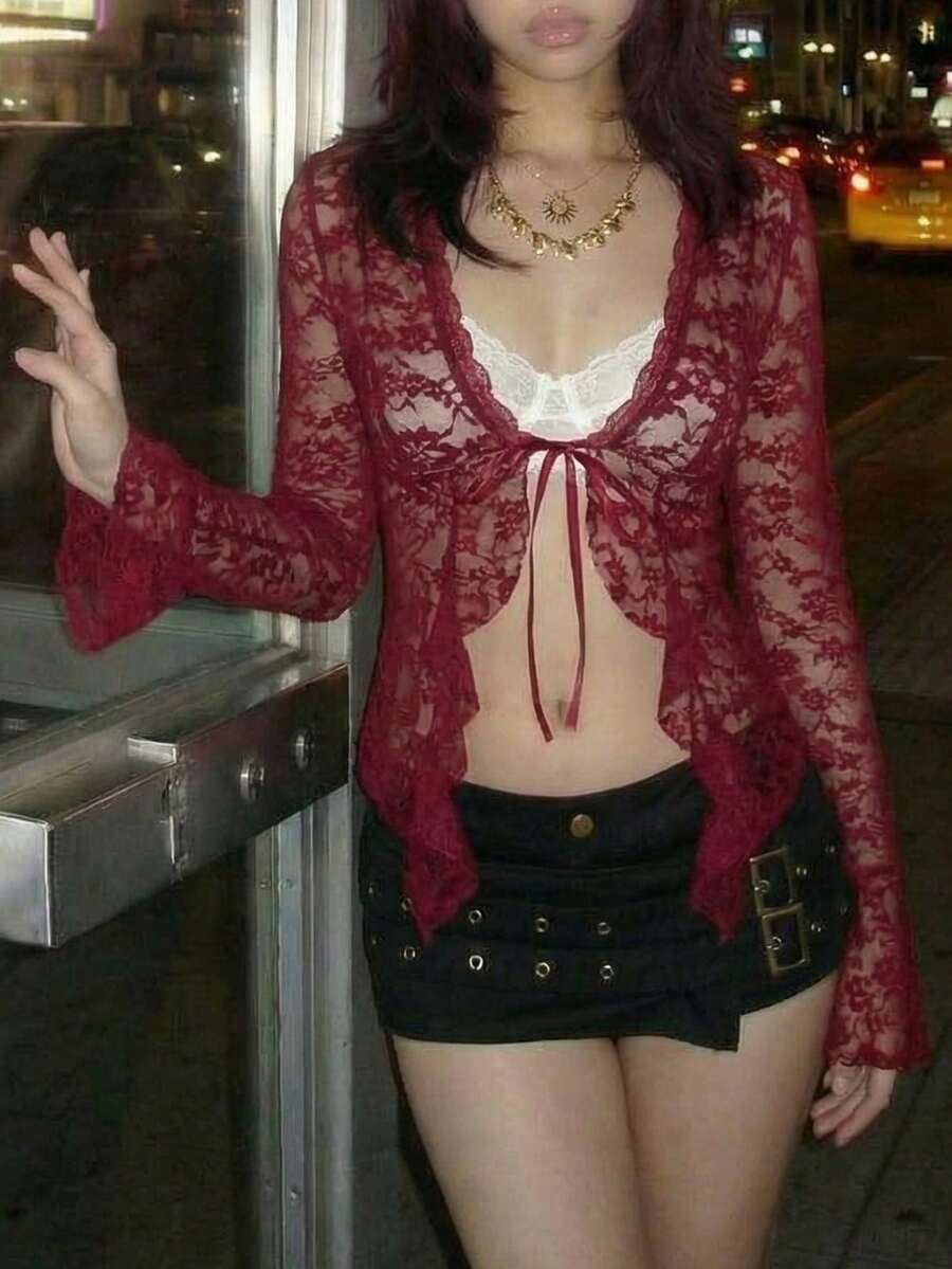 Women's semi-sheer deep V-neck top featuring cap sleeves, contrast lace trimming, and a lace-up front detail.