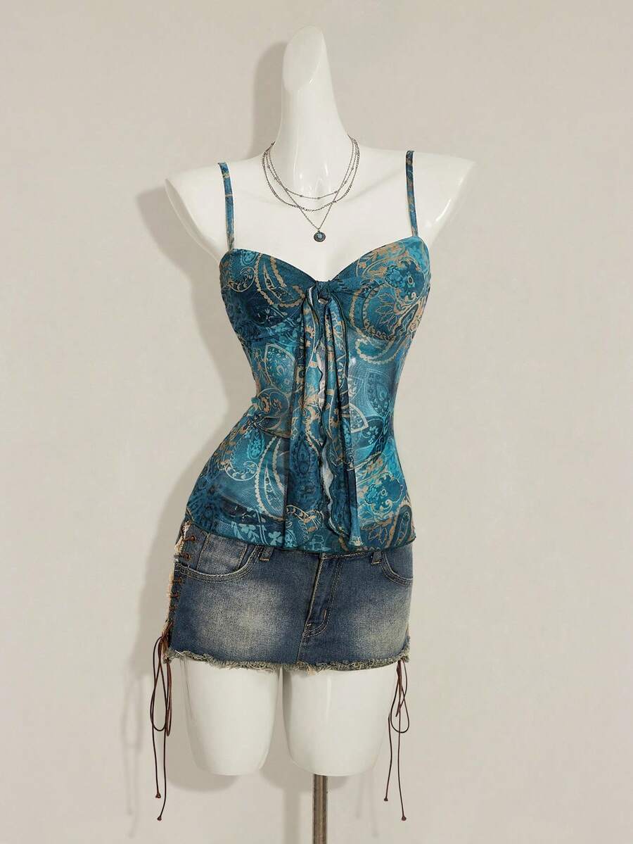 Women's green paisley print Y2K cami top with spaghetti straps, pleated styling, lace-up knot detail, and asymmetrical boho design.