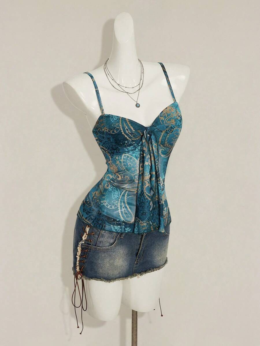 Women's green paisley print Y2K cami top with spaghetti straps, pleated styling, lace-up knot detail, and asymmetrical boho design.