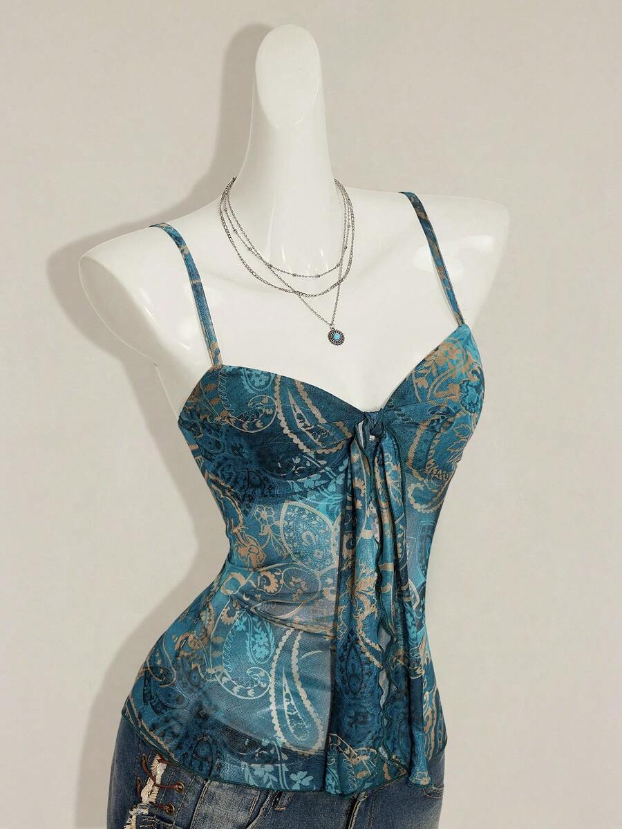 Women's green paisley print Y2K cami top with spaghetti straps, pleated styling, lace-up knot detail, and asymmetrical boho design.