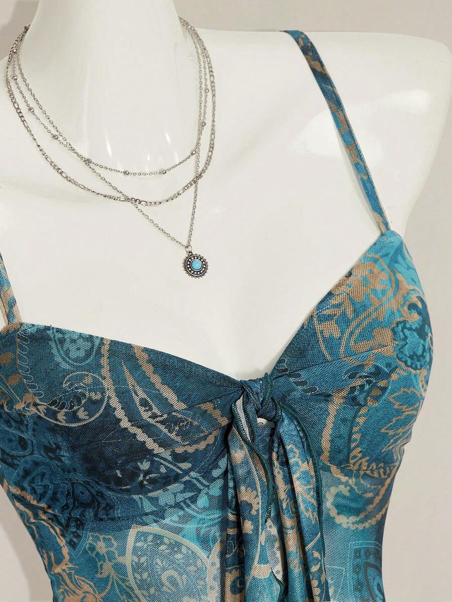 Women's green paisley print Y2K cami top with spaghetti straps, pleated styling, lace-up knot detail, and asymmetrical boho design.