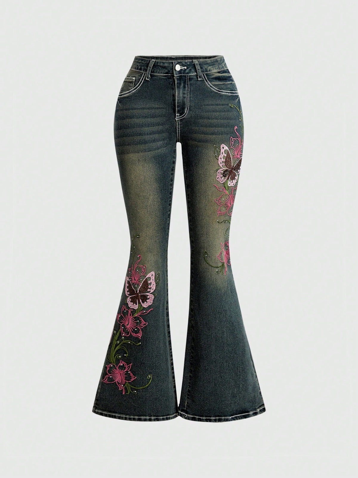 Women's blue ultra low waist flare jeans with butterfly vine embroidery and rhinestone detailing on stretch denim.