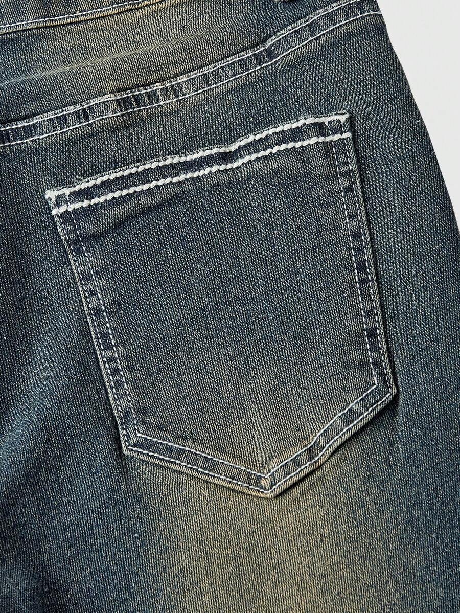 Women's blue ultra low waist flare jeans with butterfly vine embroidery and rhinestone detailing on stretch denim.