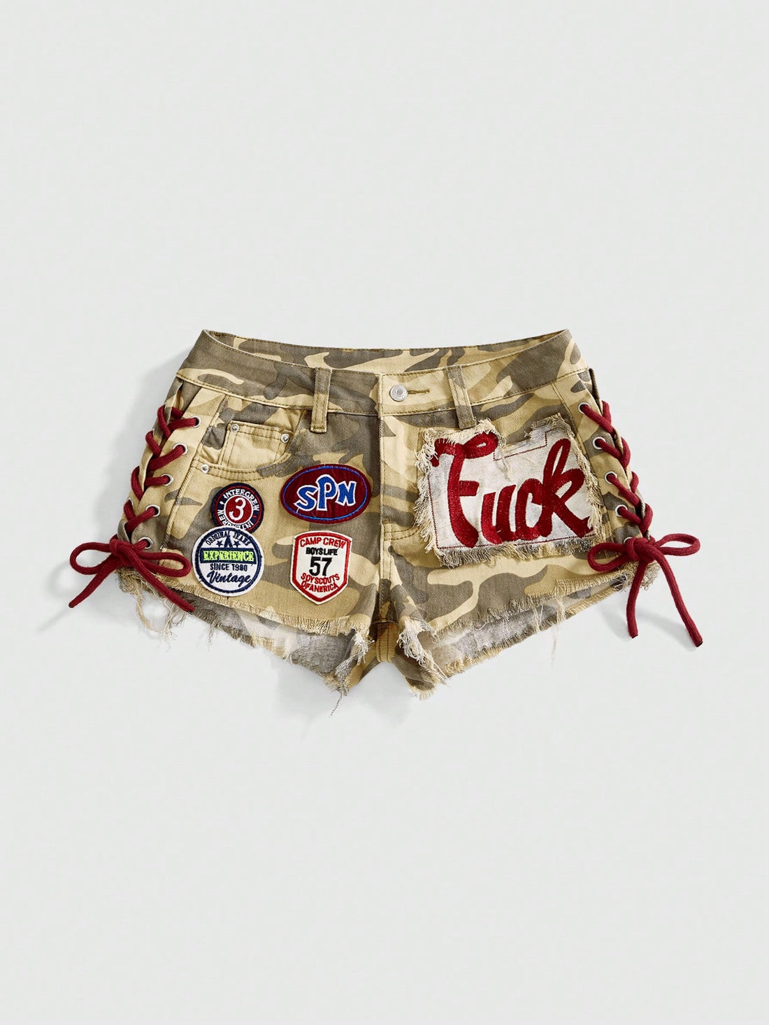 Women's Y2K low waist camo mini skort shorts featuring lace-up knot details, grommet eyelets, graphic lettering pattern, and a zipper fly.