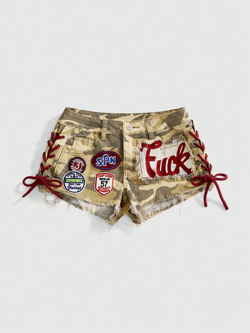 Women's Y2K low waist camo mini skort shorts featuring lace-up knot details, grommet eyelets, graphic lettering pattern, and a zipper fly.