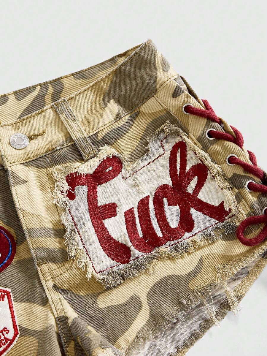 Women's Y2K low waist camo mini skort shorts featuring lace-up knot details, grommet eyelets, graphic lettering pattern, and a zipper fly.