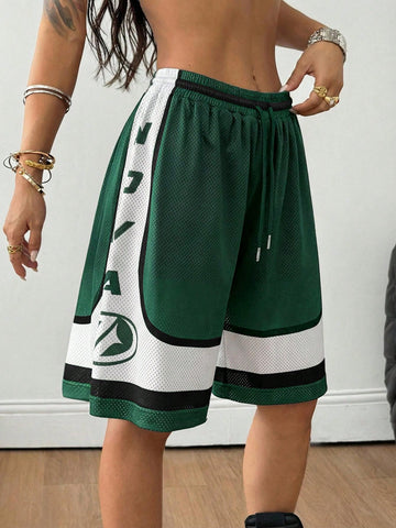 Green loose fit mesh track shorts featuring side stripes, drawstring waistband, and letter print detailing