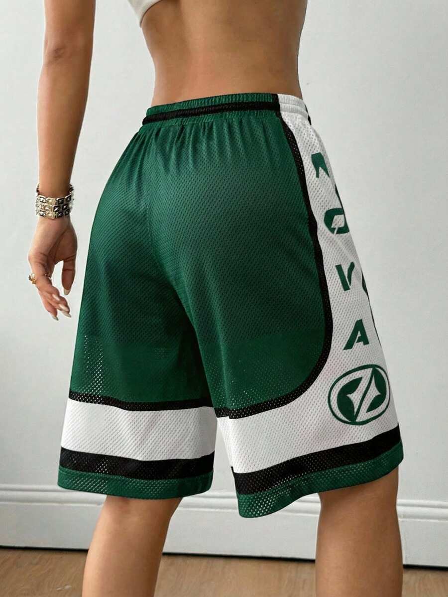 Green loose fit mesh track shorts featuring side stripes, drawstring waistband, and letter print detailing