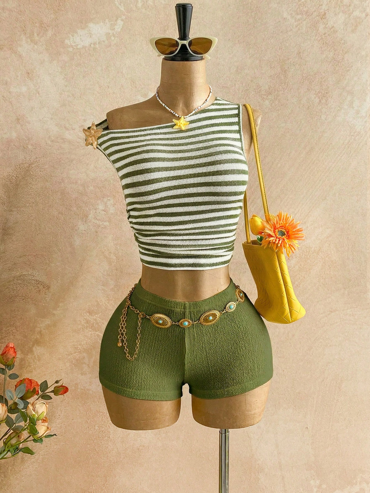 Women's black fuzzy knit two-piece set with an asymmetrical crop camisole top featuring ruched detail and cutout back, paired with matching mini shorts.