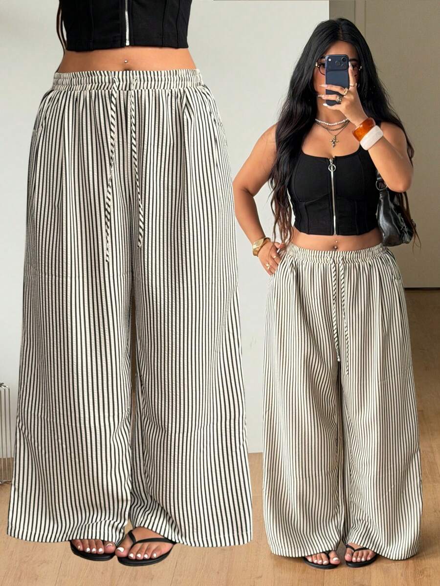 Plus size women's striped loose straight leg cropped pants with pleated detailing and side pockets