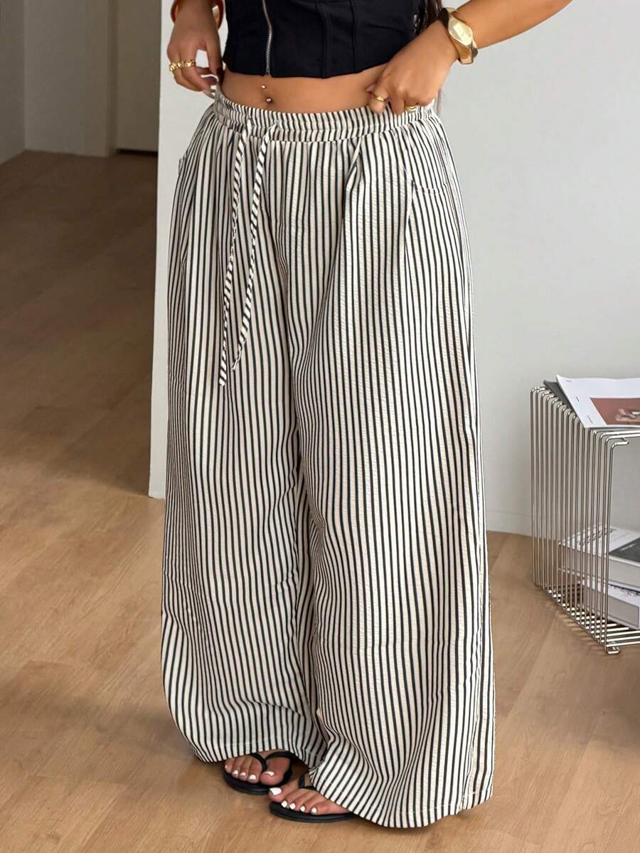 Plus size women's striped loose straight leg cropped pants with pleated detailing and side pockets