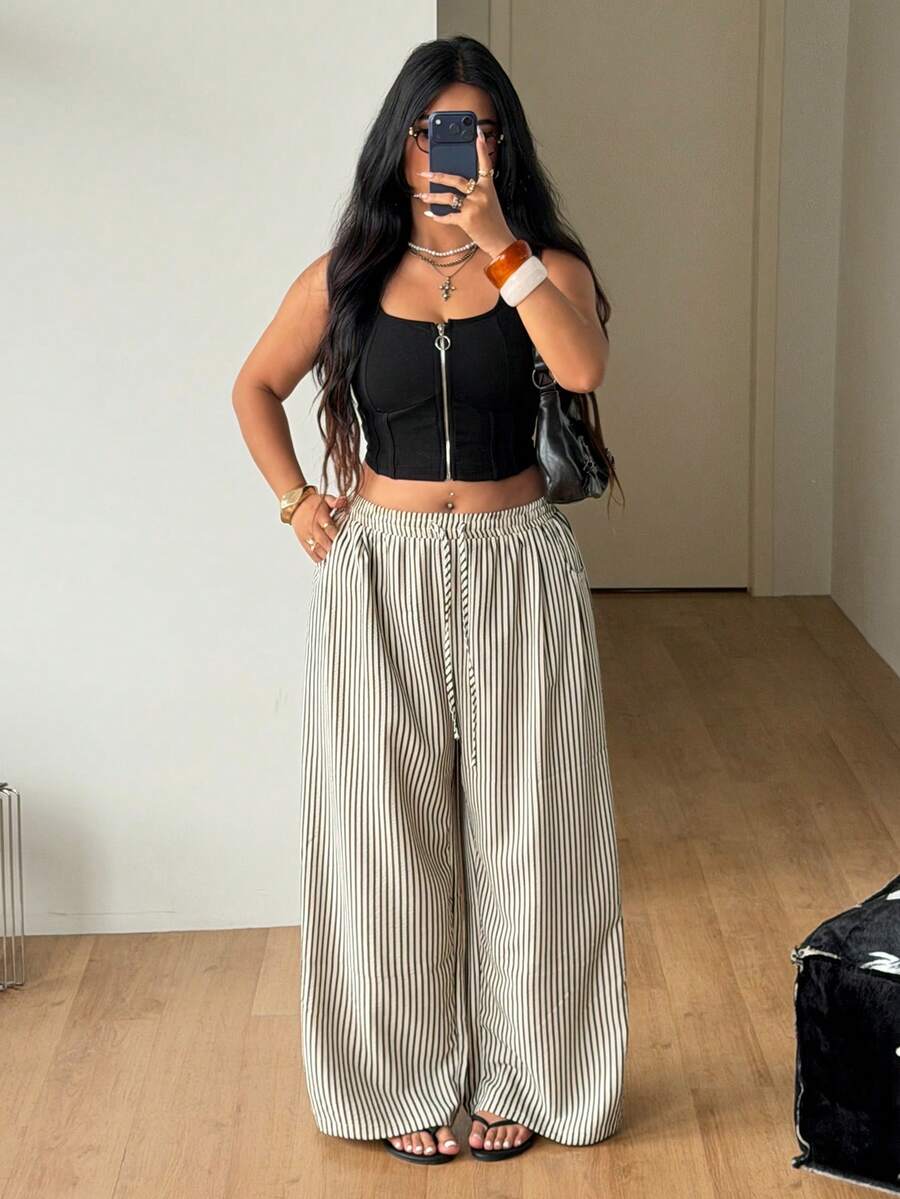 Plus size women's striped loose straight leg cropped pants with pleated detailing and side pockets