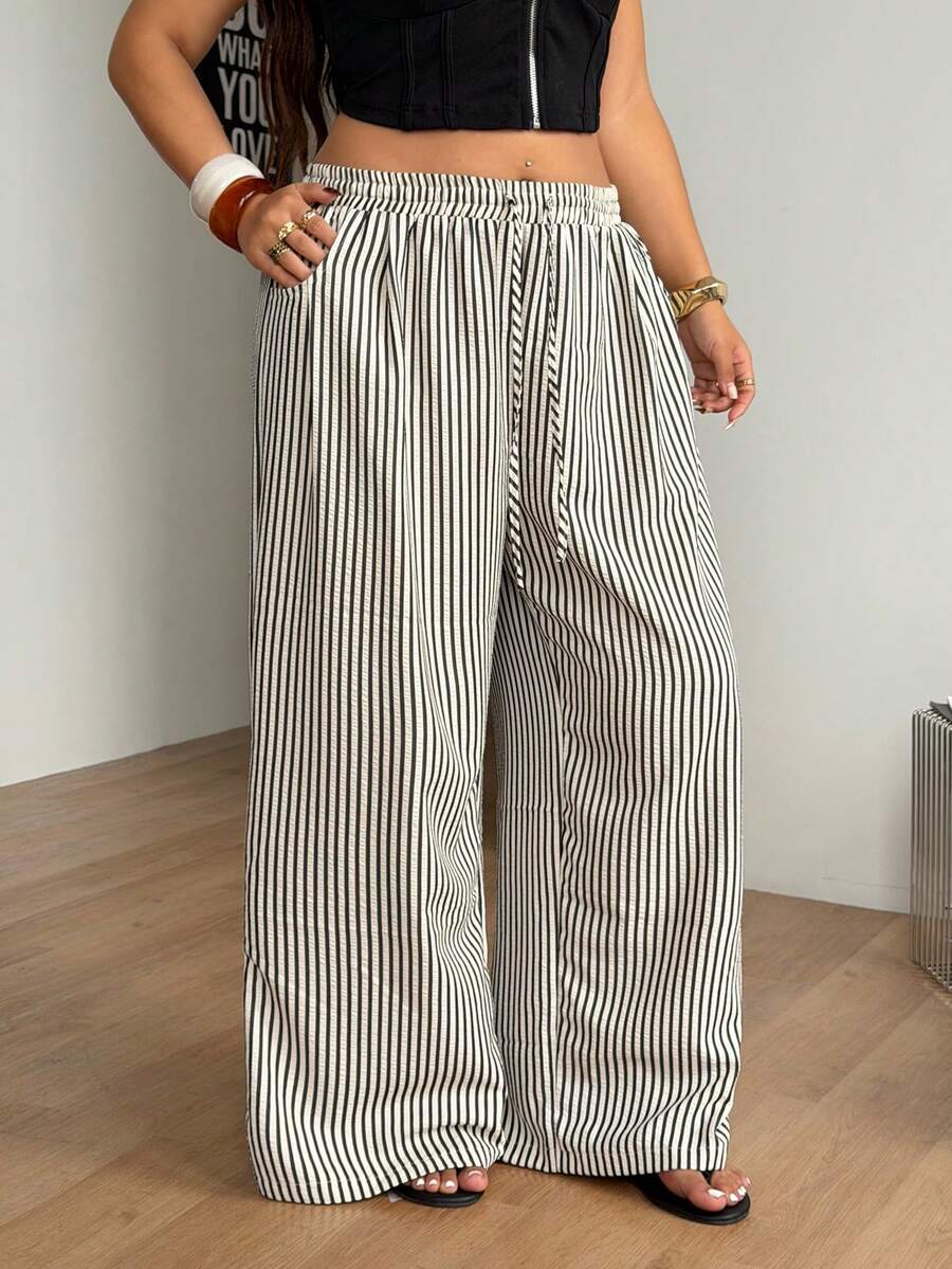Plus size women's striped loose straight leg cropped pants with pleated detailing and side pockets