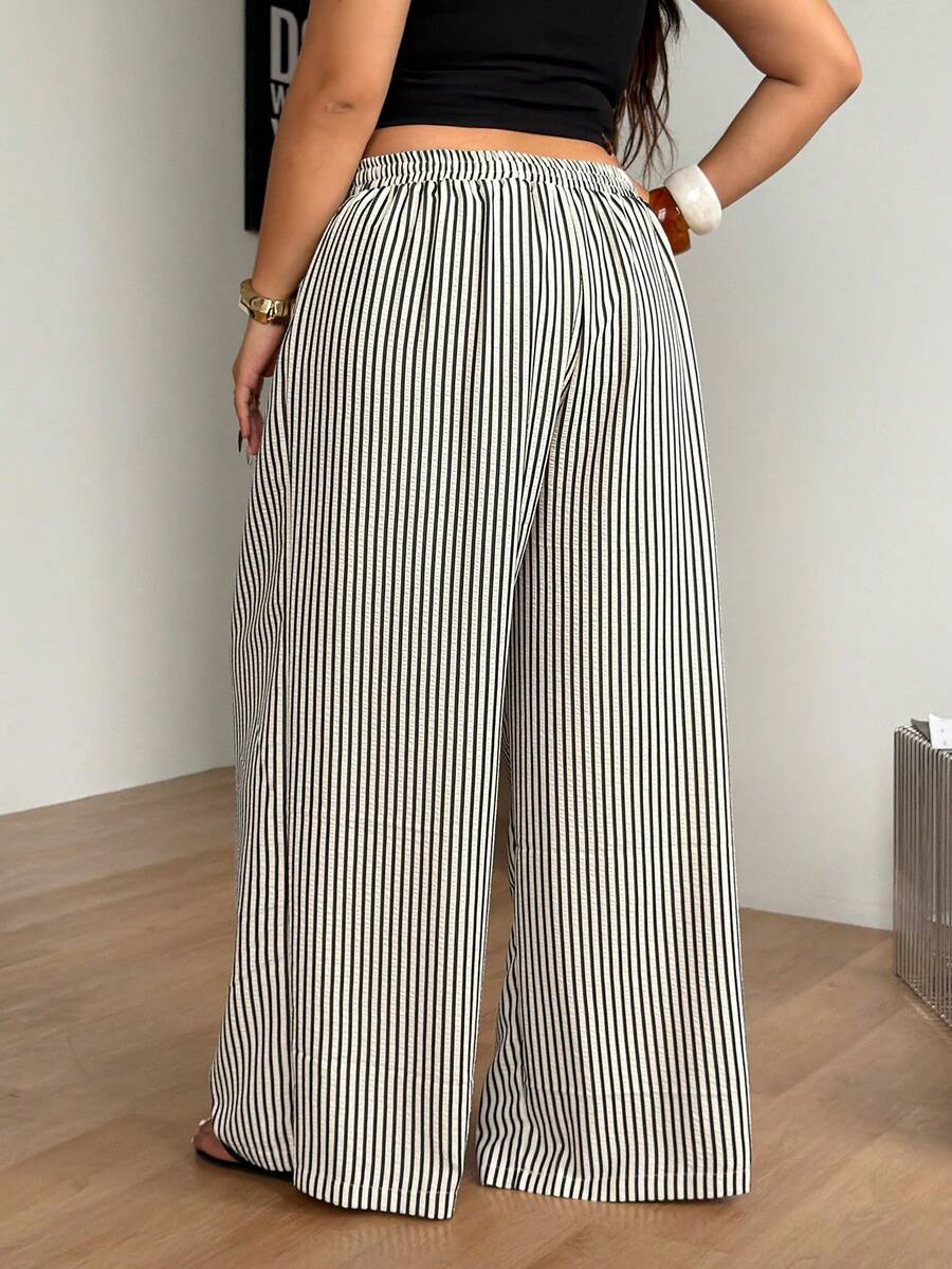 Plus size women's striped loose straight leg cropped pants with pleated detailing and side pockets