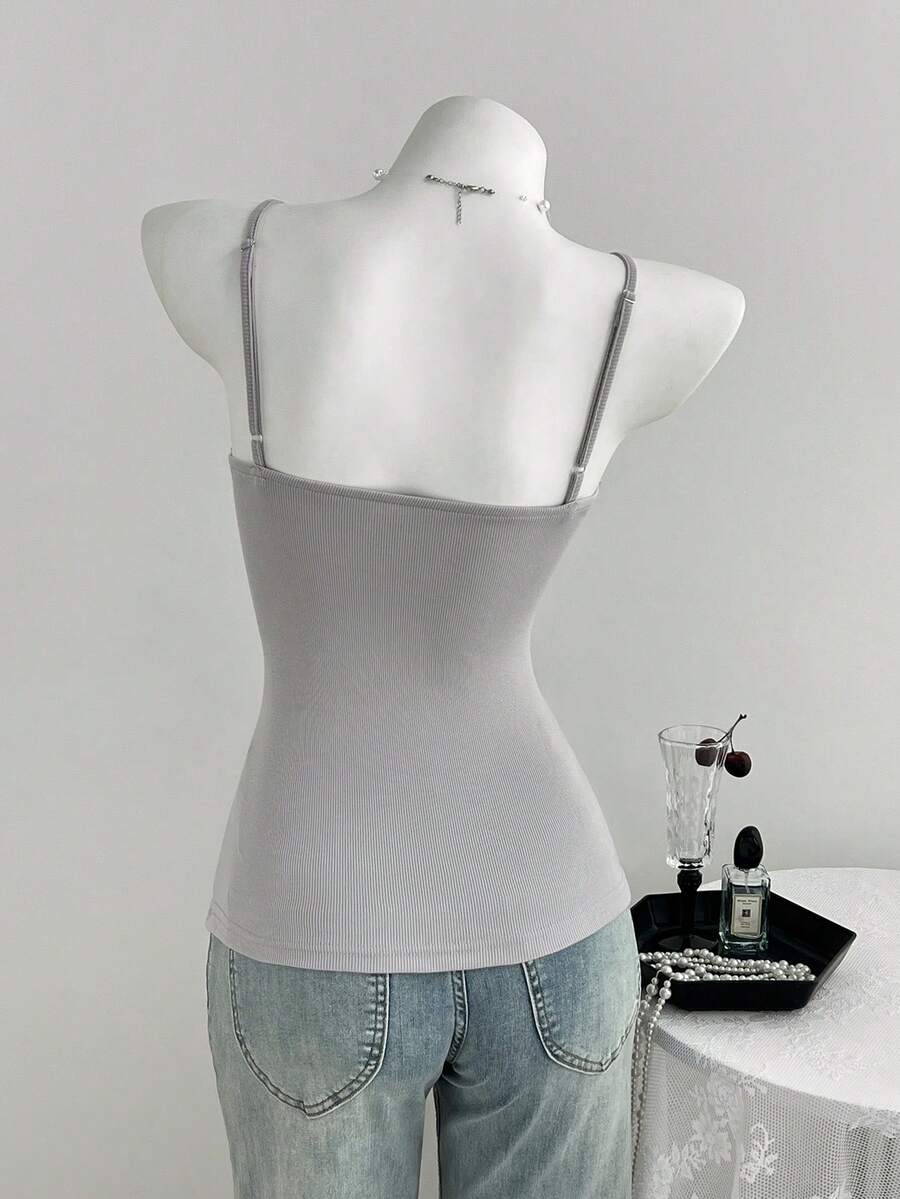 Women's slim fit backless cami tank top with contrast lace patchwork details, spaghetti straps, and high-stretch knitted ribbed fabric.