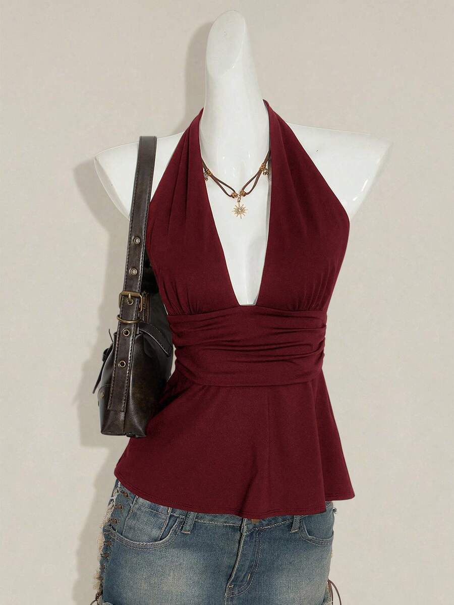Women's backless halter babydoll tank top featuring a square neckline, slim fit silhouette, and a flared ruffle hem.