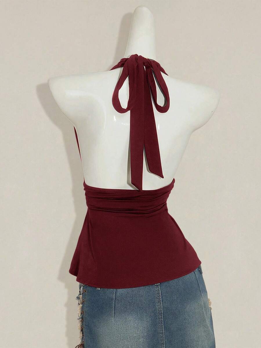 Women's backless halter babydoll tank top featuring a square neckline, slim fit silhouette, and a flared ruffle hem.
