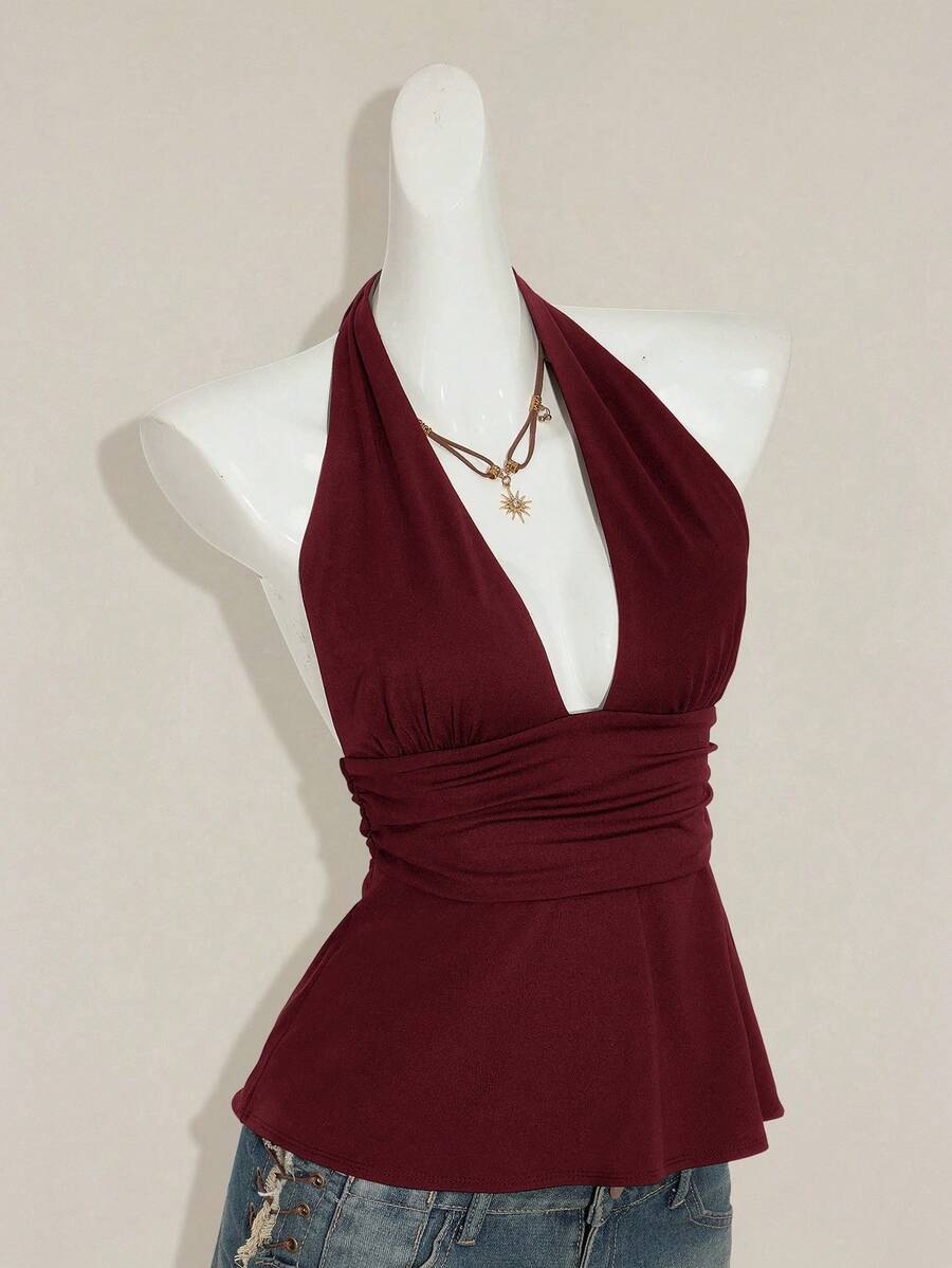 Women's backless halter babydoll tank top featuring a square neckline, slim fit silhouette, and a flared ruffle hem.