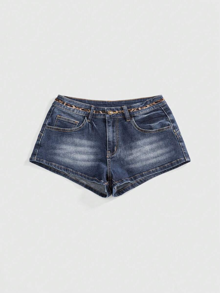 Women's super low waist shorts with leopard print embroidery, button and zipper closure, and raw hem detailing.