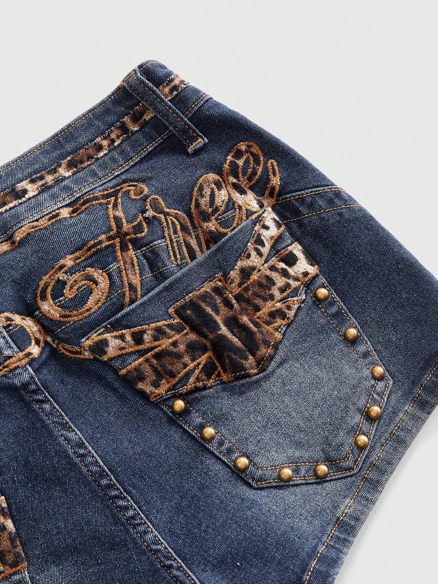 Women's super low waist shorts with leopard print embroidery, button and zipper closure, and raw hem detailing.