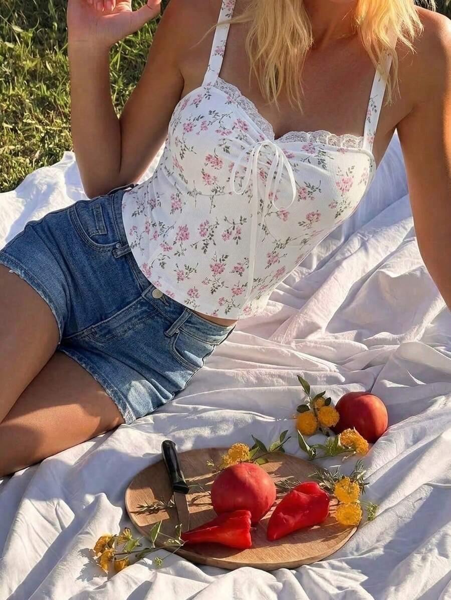 Black crop camisole top for women featuring shoulder straps, cold shoulder sleeves, drawstring detail, and frill trim on plain knitted fabric.