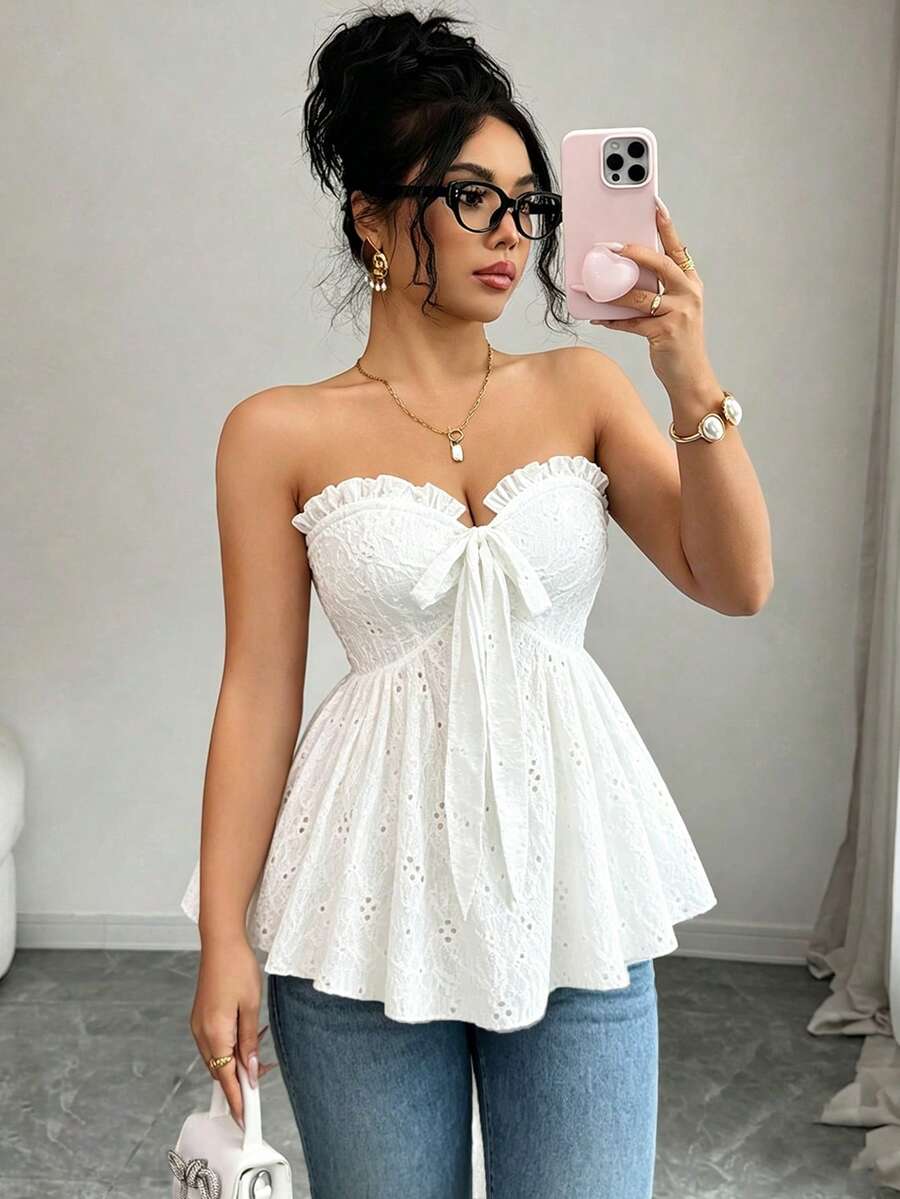 Elenzga white knitted sleeveless camisole top featuring spaghetti straps, front bow detail, hollow-out waist, and frill trim hem.