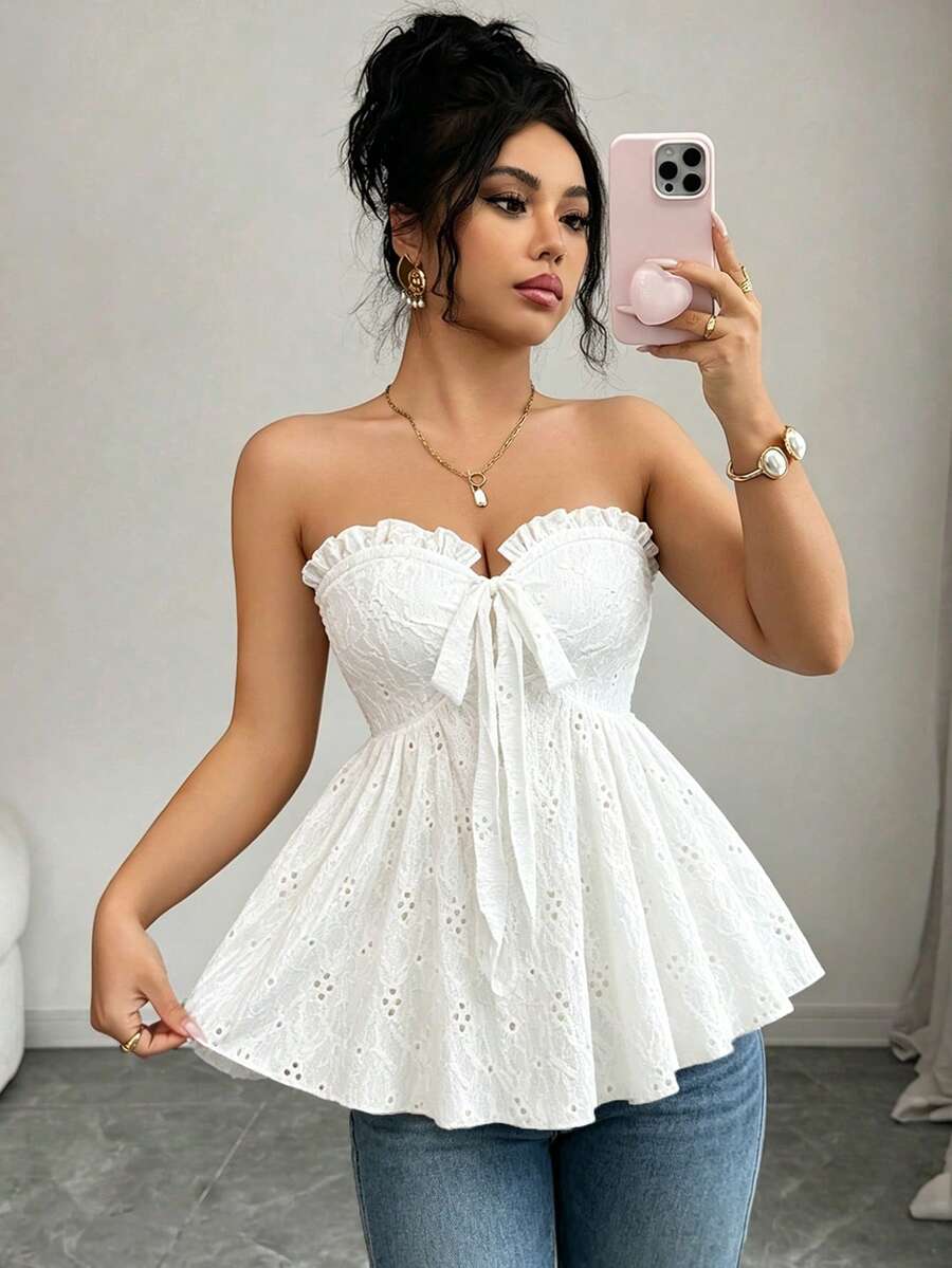 Elenzga white knitted sleeveless camisole top featuring spaghetti straps, front bow detail, hollow-out waist, and frill trim hem.