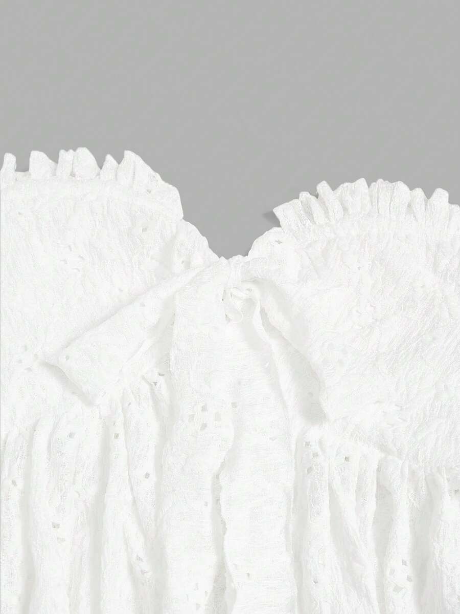 Elenzga white knitted sleeveless camisole top featuring spaghetti straps, front bow detail, hollow-out waist, and frill trim hem.