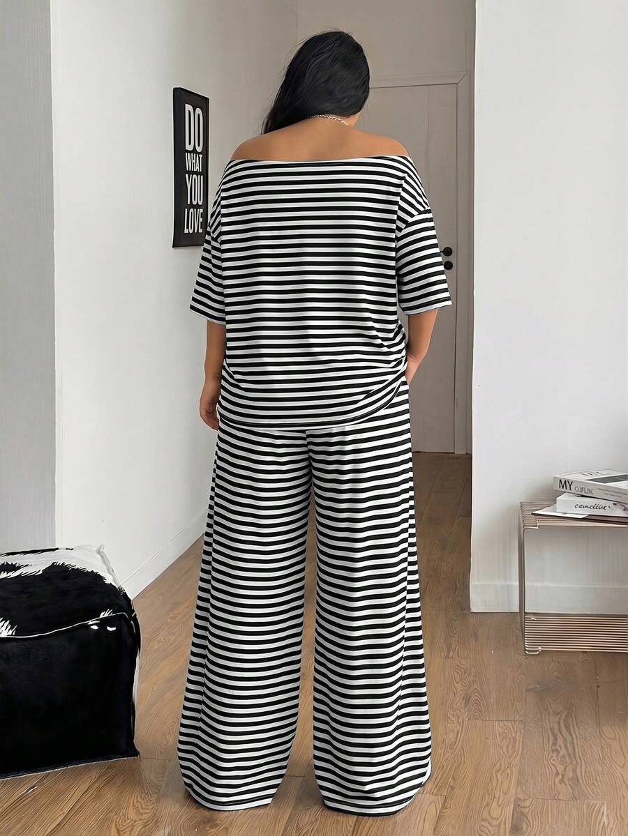 Women's casual two-piece outfit featuring a loose short-sleeve asymmetrical neck t-shirt and matching long wide leg pants with pockets.