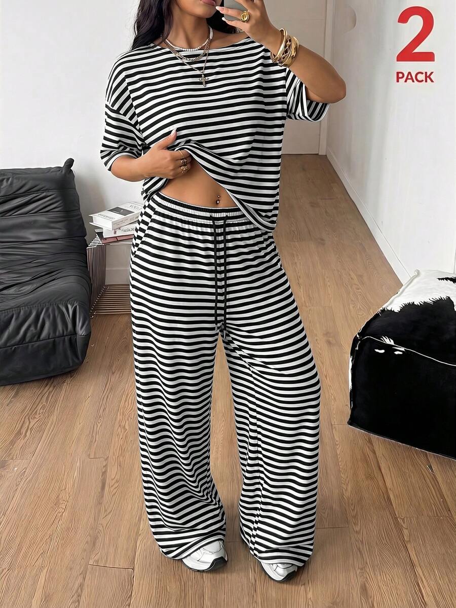 Women's casual two-piece outfit featuring a loose short-sleeve asymmetrical neck t-shirt and matching long wide leg pants with pockets.
