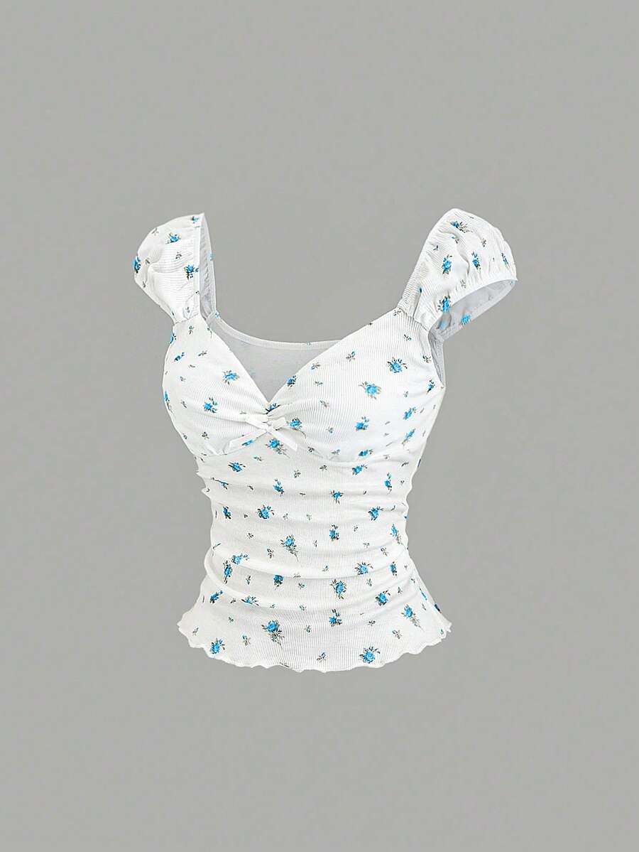 Women's short sleeve knit top with a sweetheart neckline and ruched twist knot front detail.