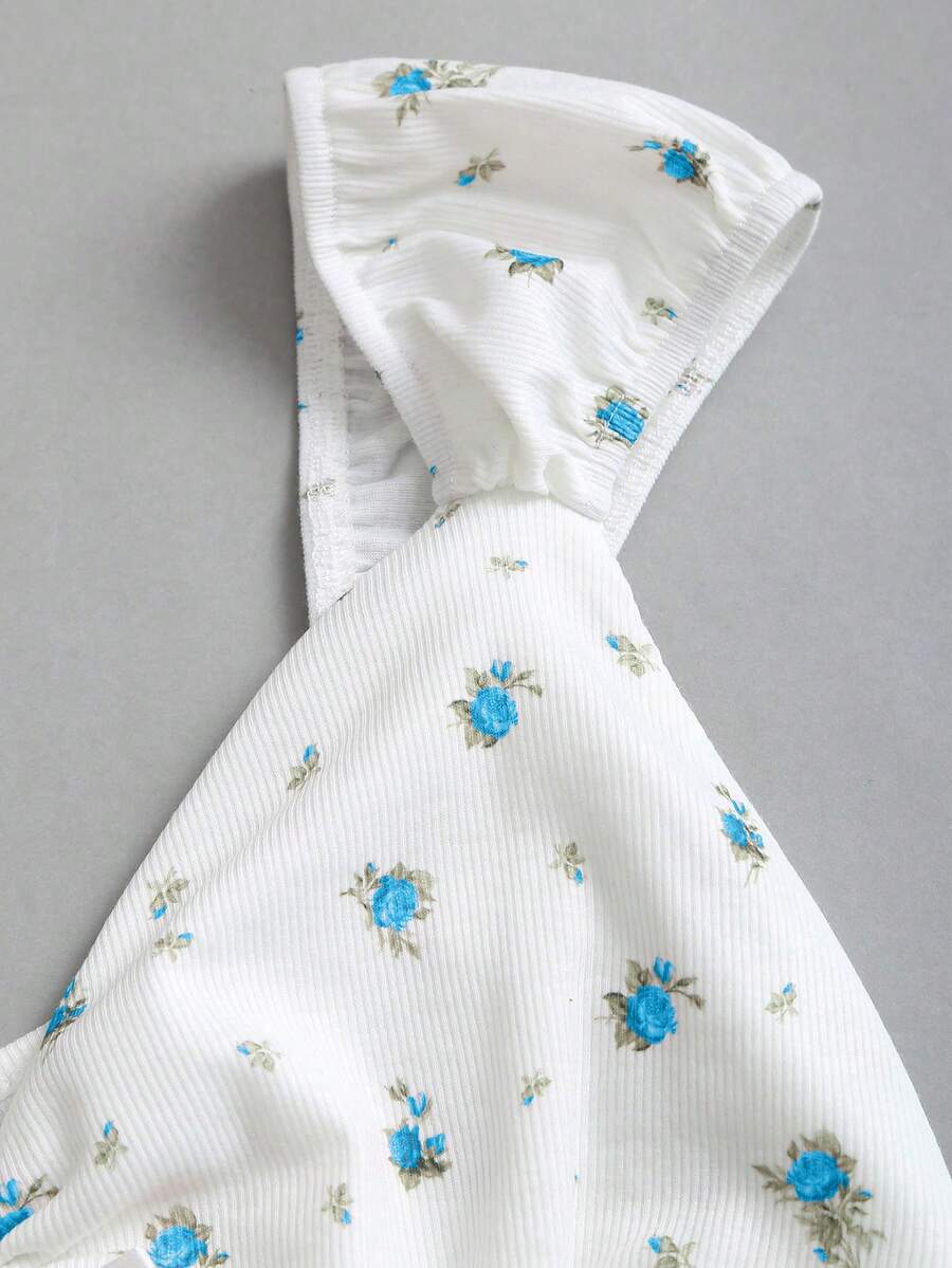 Women's short sleeve knit top with a sweetheart neckline and ruched twist knot front detail.