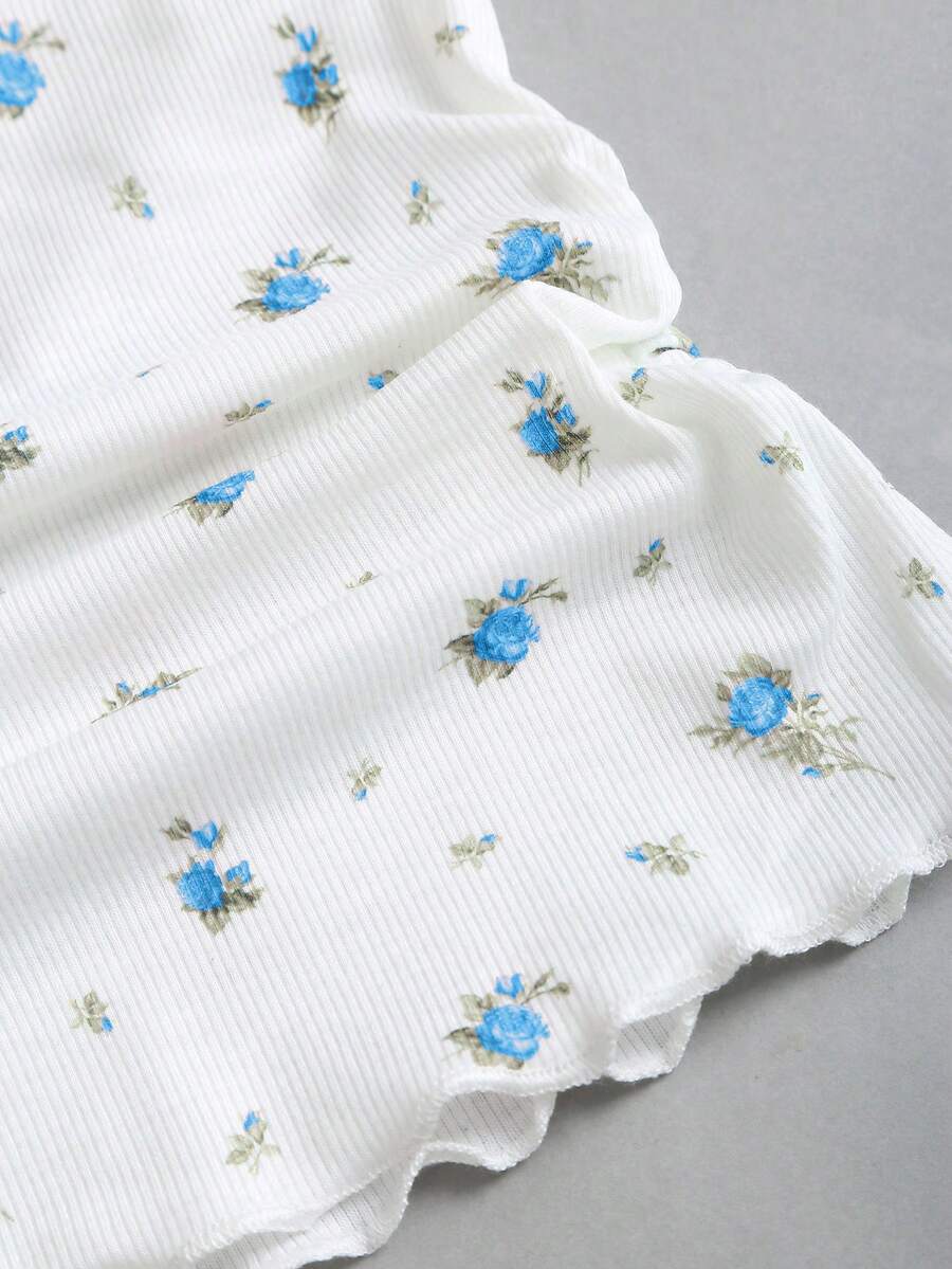 Women's short sleeve knit top with a sweetheart neckline and ruched twist knot front detail.
