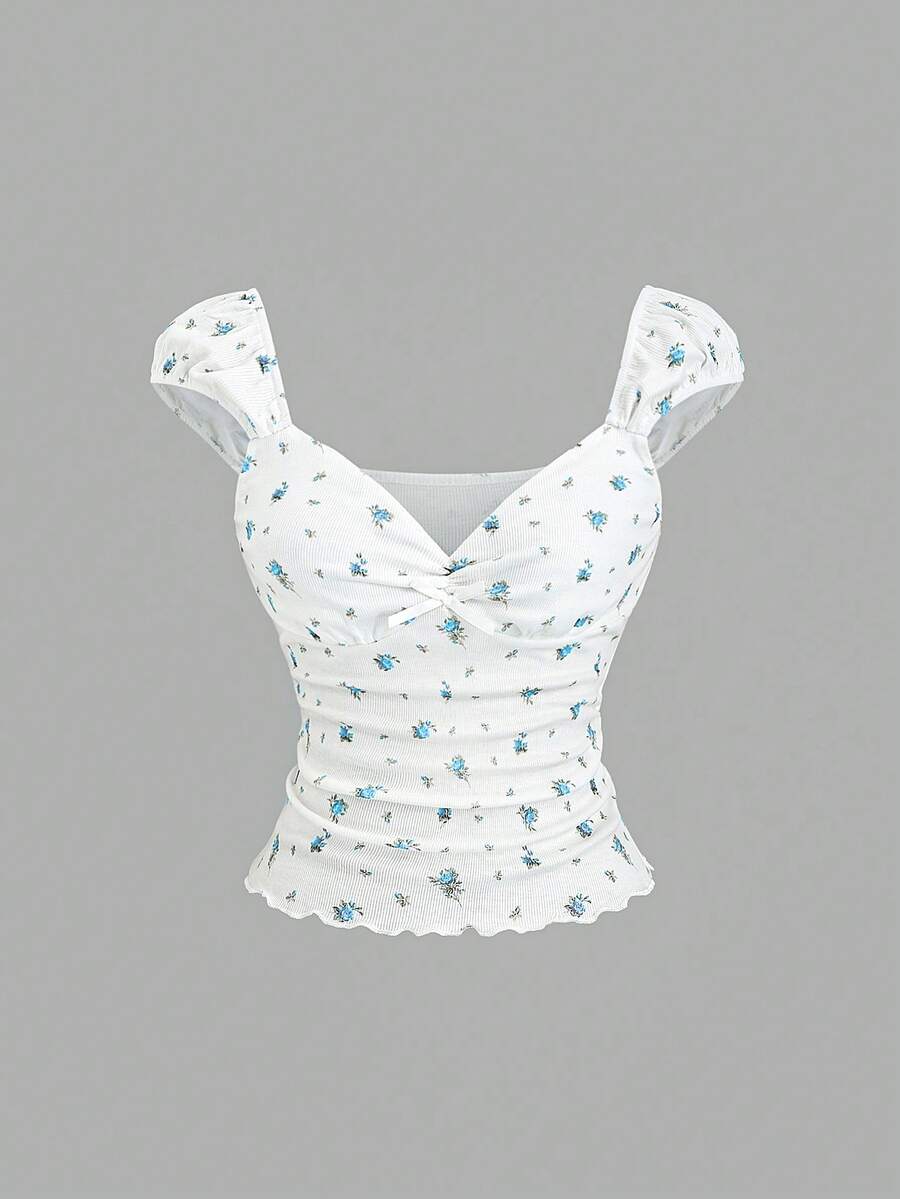 Women's short sleeve knit top with a sweetheart neckline and ruched twist knot front detail.