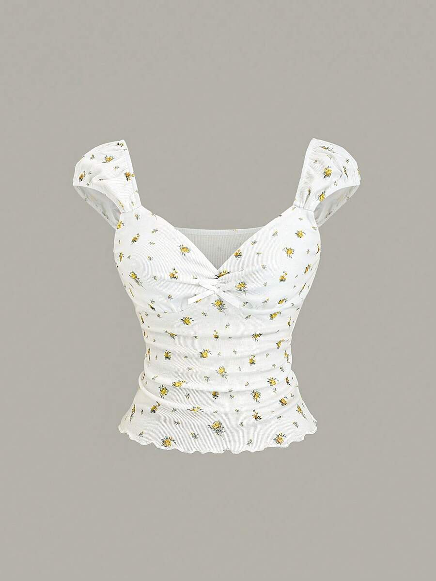 Women's short sleeve knit top with a sweetheart neckline and ruched twist knot front detail.