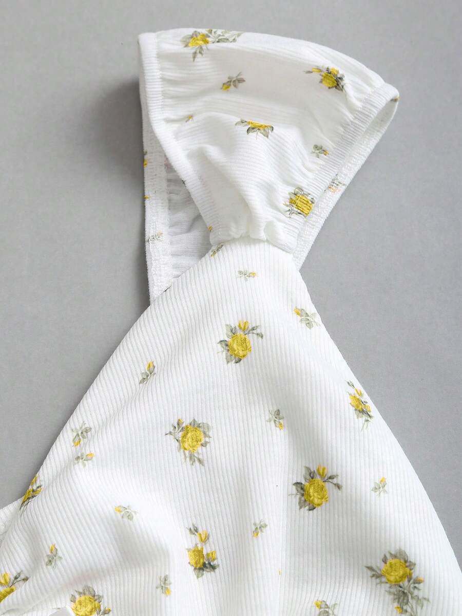 Women's short sleeve knit top with a sweetheart neckline and ruched twist knot front detail.