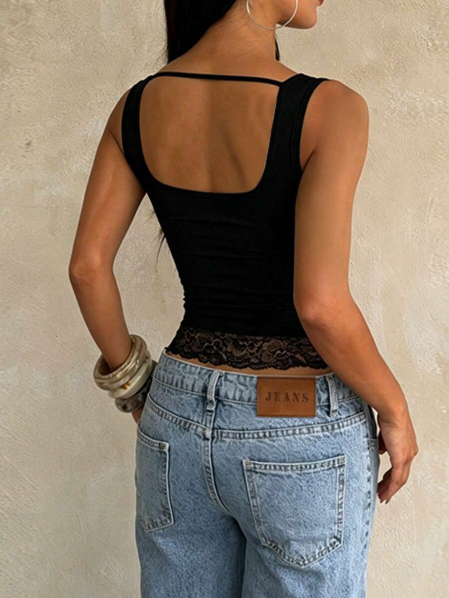 Women's white sleeveless crop tank top with contrast lace details, strap neckline, and graphic plant pattern in a slim fit.