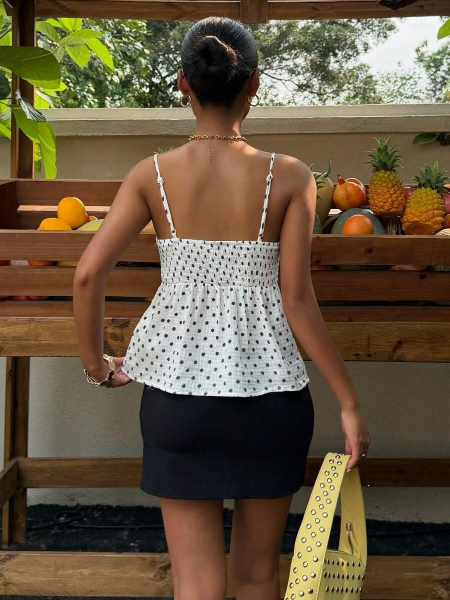 Women's casual geometric cami top with spaghetti straps, backless wrap styling, button front, and asymmetrical hem.