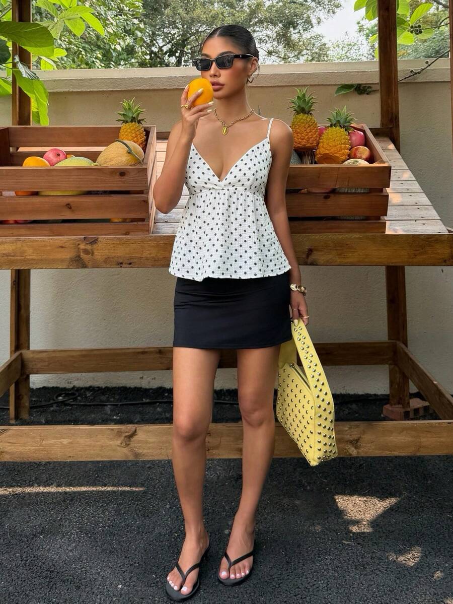 Women's casual geometric cami top with spaghetti straps, backless wrap styling, button front, and asymmetrical hem.
