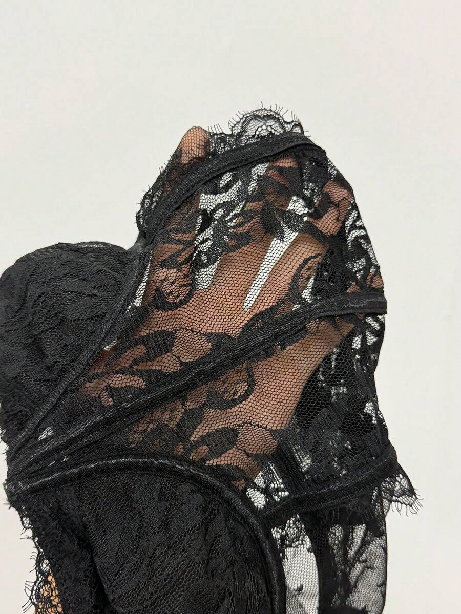 Fitted women's lace and mesh cami bodysuit with spaghetti straps.