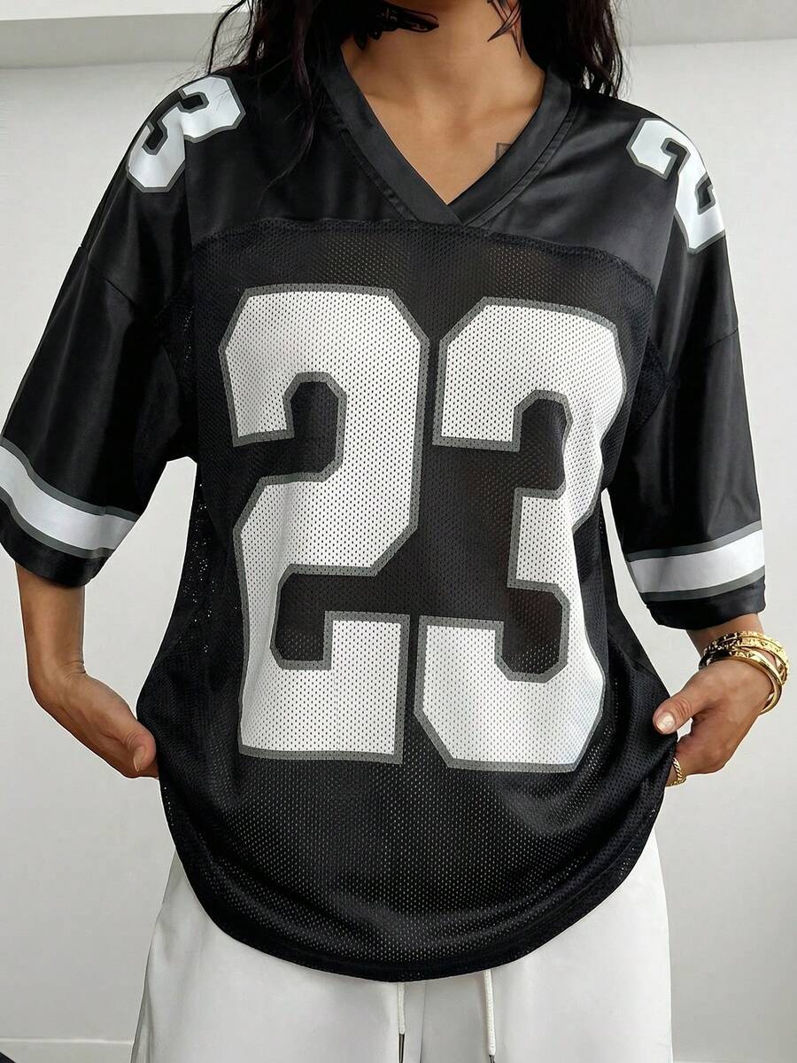 Oversized short-sleeve football jersey top featuring a V-neckline, contrast binding, and graphic number print.