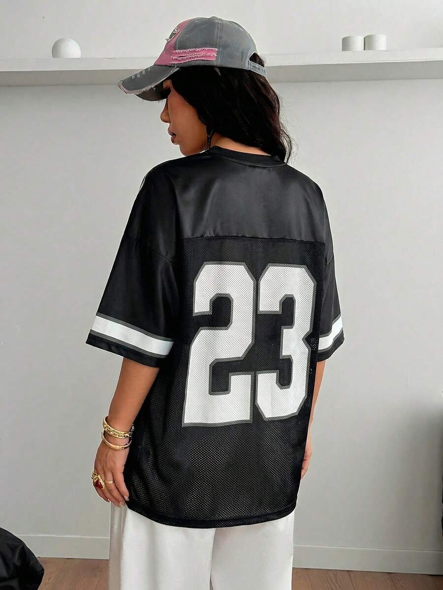 Oversized short-sleeve football jersey top featuring a V-neckline, contrast binding, and graphic number print.