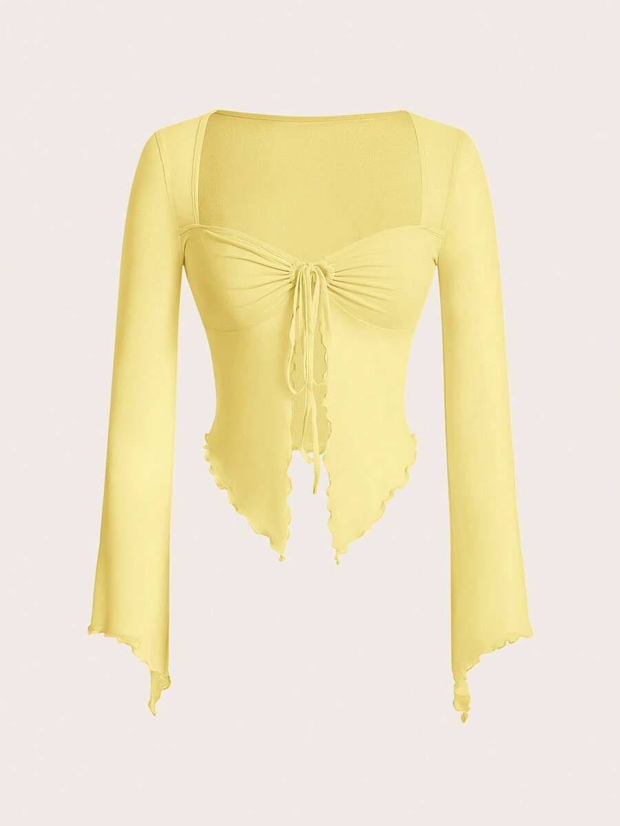 Semi-sheer mesh top featuring a sweetheart neckline with front knot detail, long flare sleeves, lined body, and an asymmetrical hem.