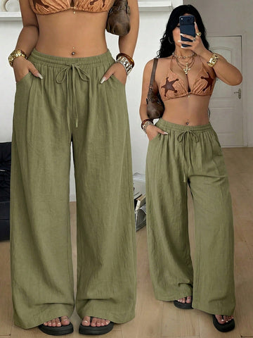 Plus size women's striped loose straight leg cropped pants with pleated detailing and side pockets