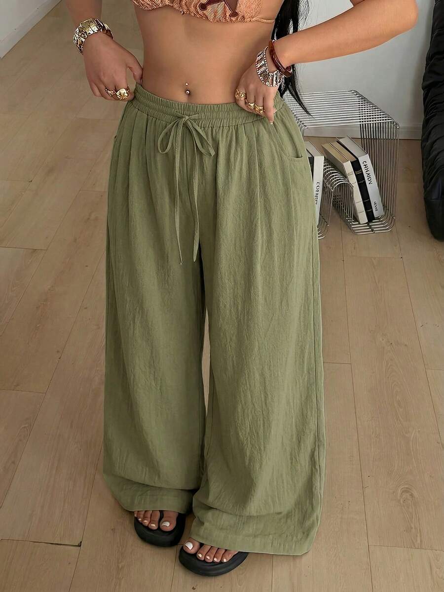 Plus size women's striped loose straight leg cropped pants with pleated detailing and side pockets